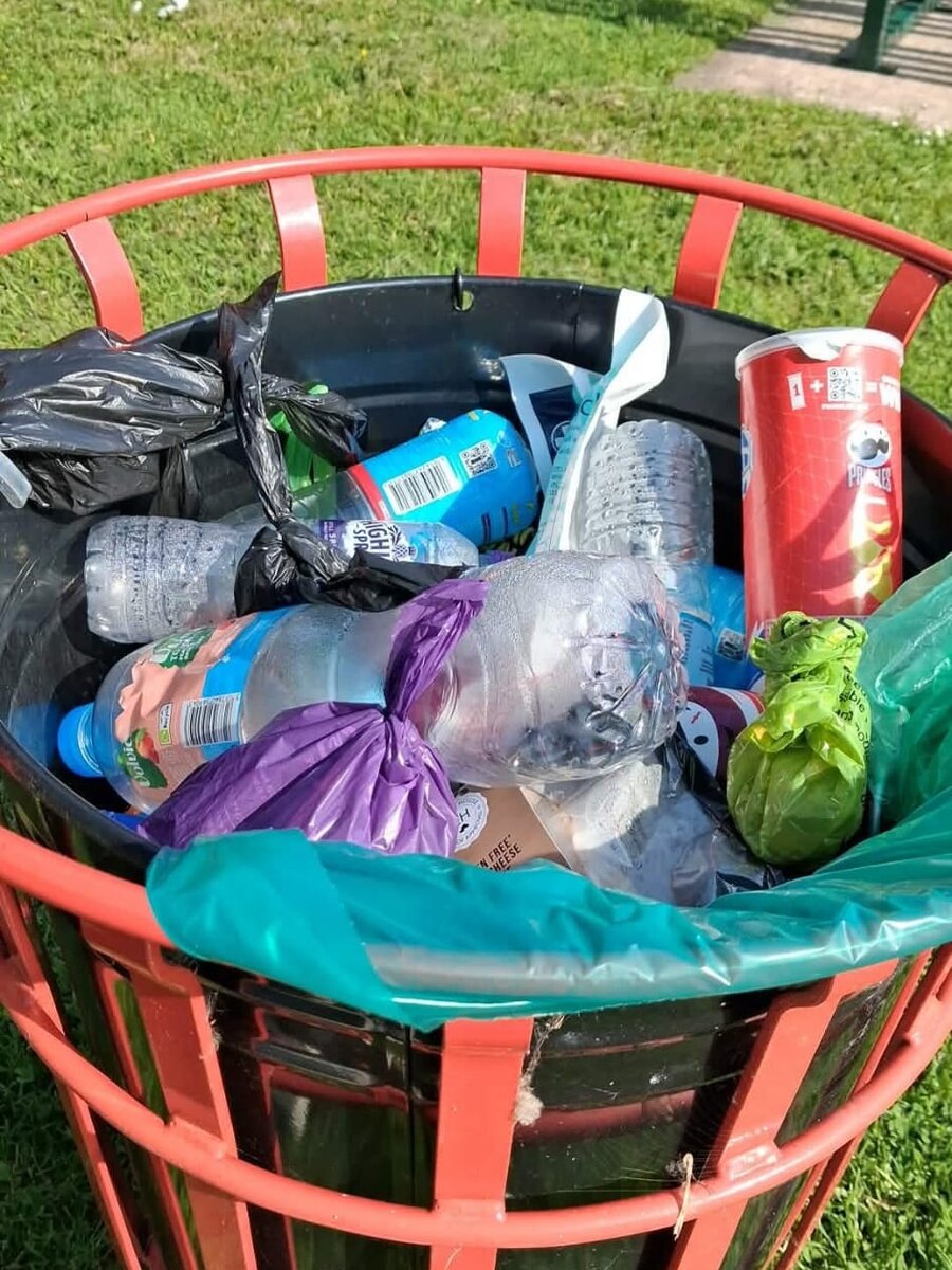 An overflowing park litter bin showing the results of the community litter pick