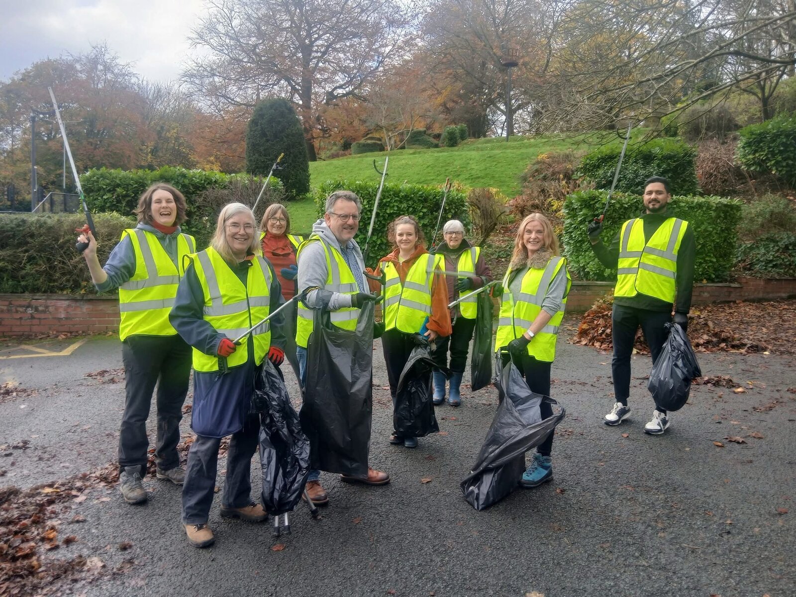 Volunteers in hi-vis jackets with litter pickers and black bags at Verdin Park in November 2025