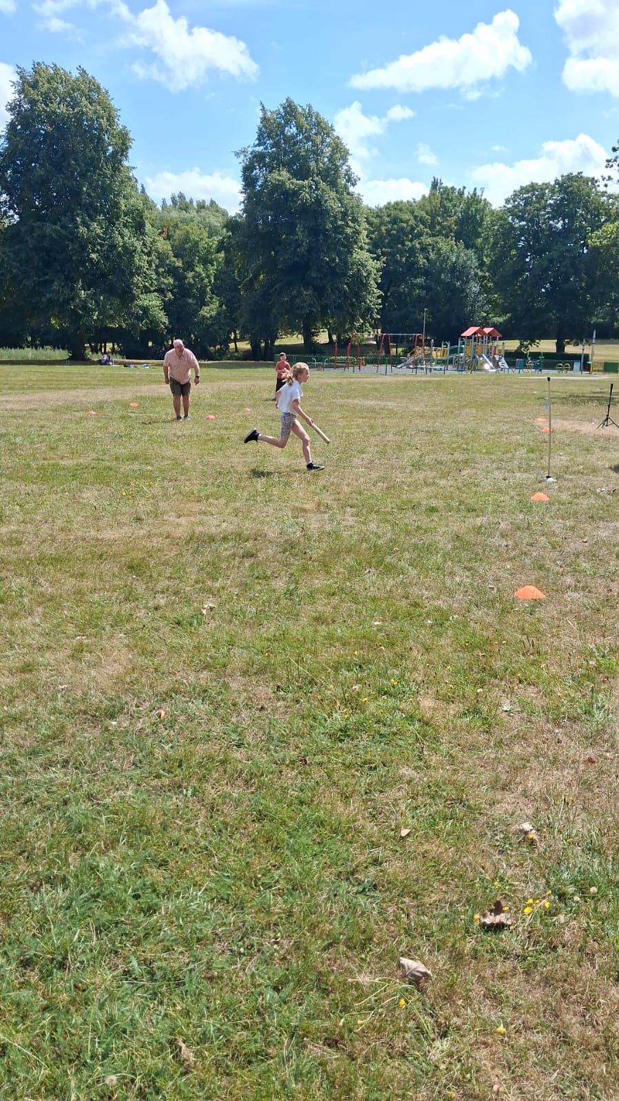 A young rounders player running the bases during Picnic in the Park