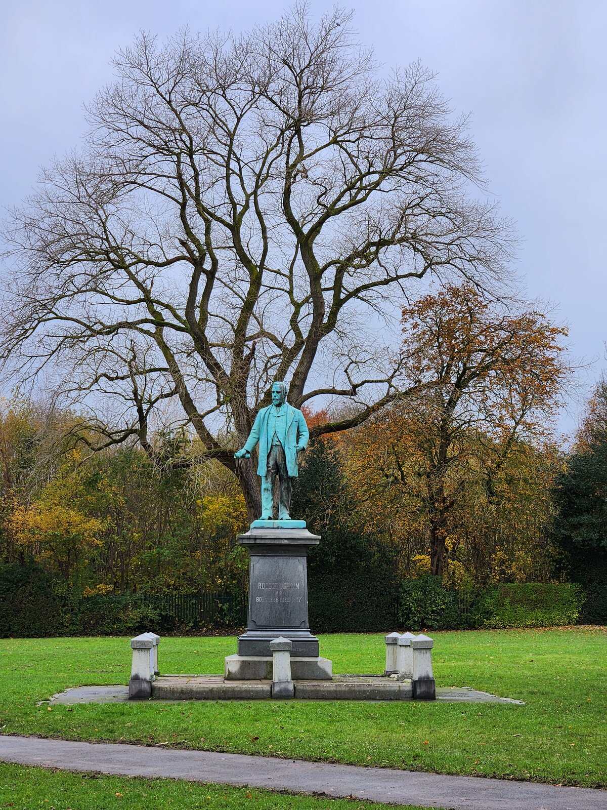 The Verdin Park memorial statue in autumn, surrounded by golden trees