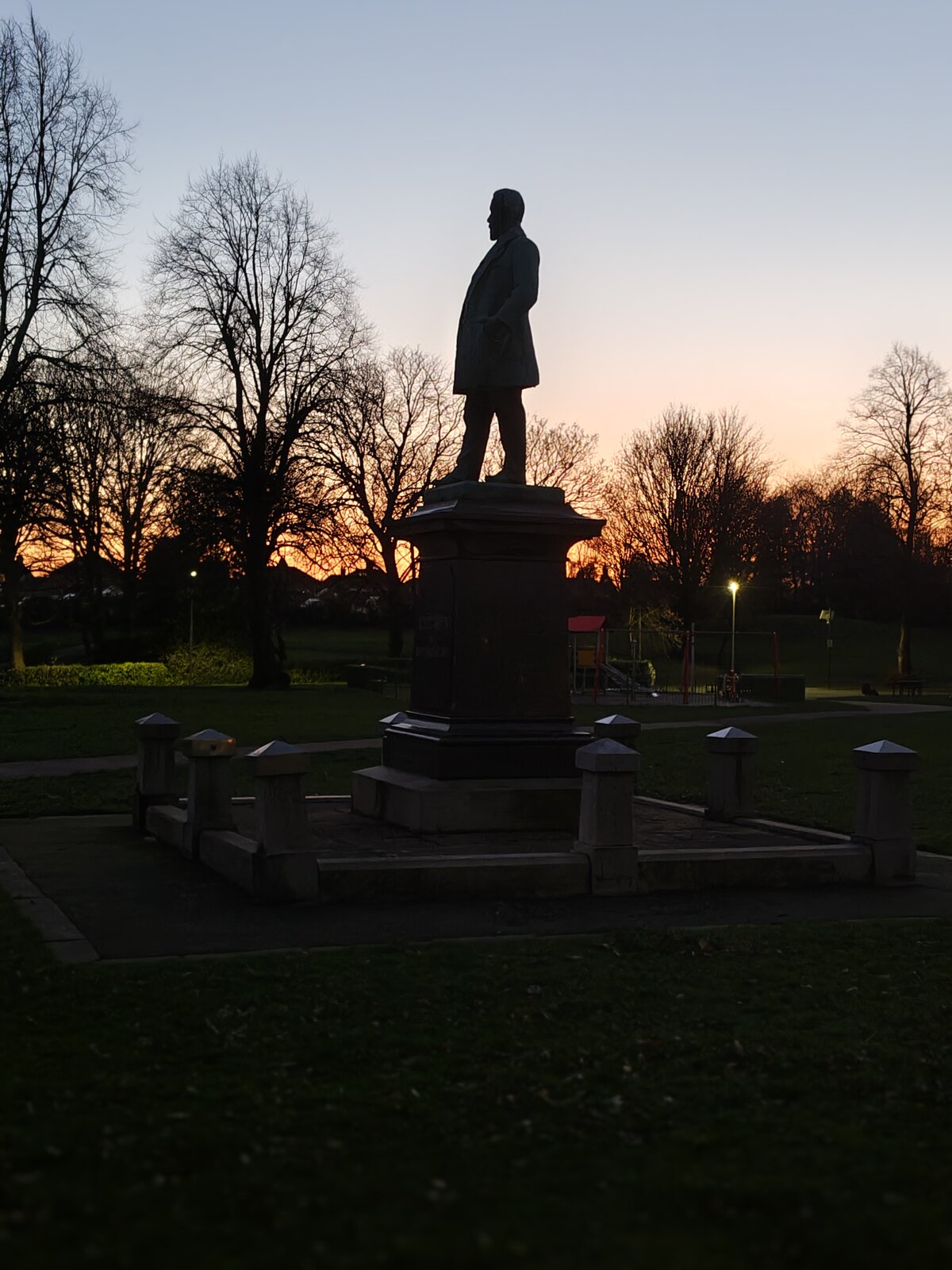 The Robert Verdin memorial statue silhouetted at sunset